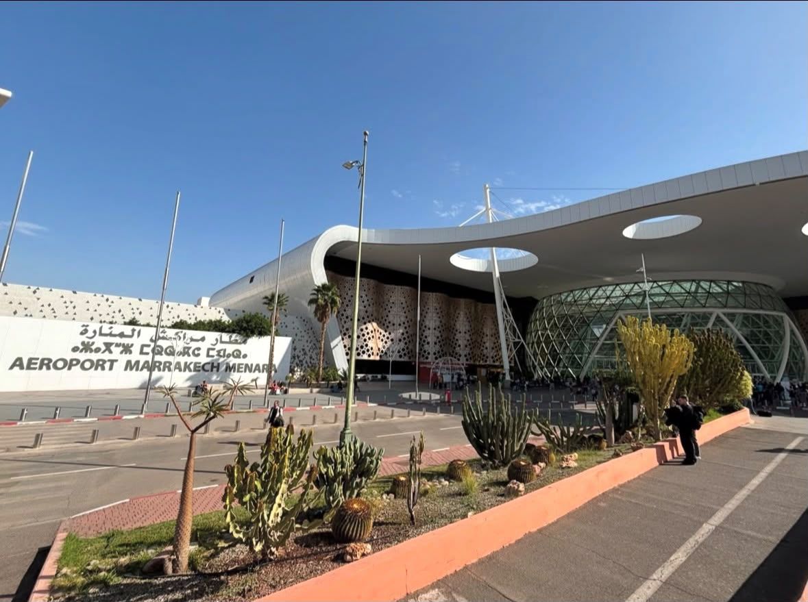 Aeroport Marrakech Menara entrance sign with a desert cactus garden