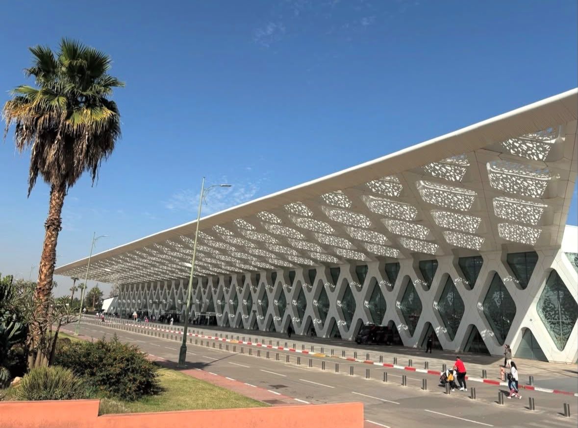 Marrakech Menara Airport departures canopy with a palm tree, RAK terminal exterior